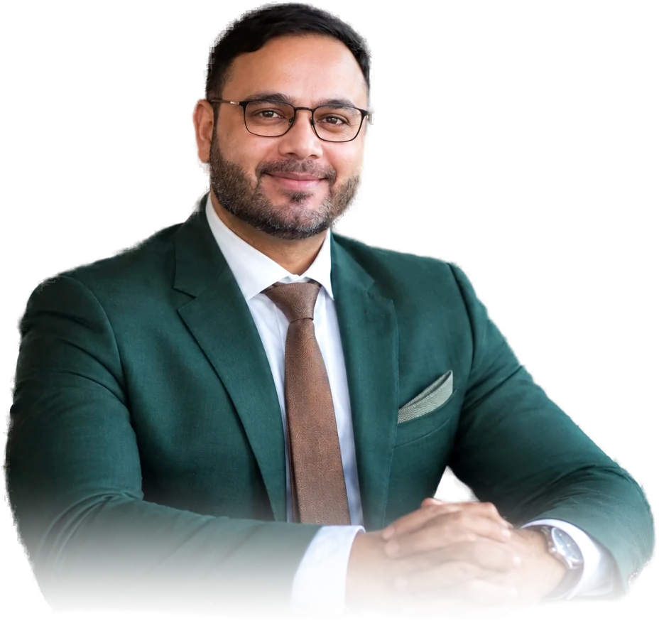 Mohit Bhatnagar, seated, in a dark green suit and tan tie.